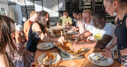 Gemeinsam essen Teilnehmende und Freiwillige am gedeckten Tisch