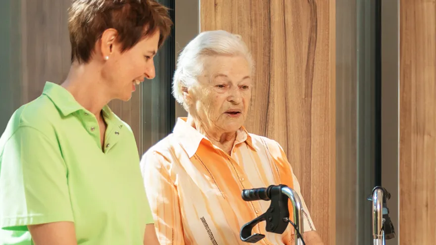 Pflegehelferin kümmert sich um Patientin mit psychischer Beeinträchtigung