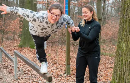Eine Freiwille des Roten Kreuzes Zürich trainiert mit ihrem Mentee im Wald.